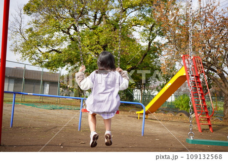 秋の公園でブランコに乗っている小学4年生の女の子の後ろ姿 秋の公園でブランコに乗っている小学4年生の女の子の後ろ姿 109132568