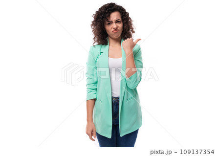 young slim caucasian female model with curly black hair points with index finger 109137354