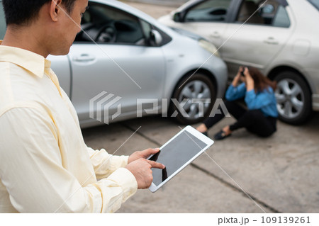 Businessman using a smartphone to take a photo to send to insurance. Concept of claim insurance for a car accident online after send photo and evidence to the insurance company 109139261