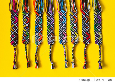 Unfinished DIY woven friendship bracelets with abstract geometric pattern. Summer accessories Unfinished DIY woven friendship bracelets with abstract geometric pattern. Summer accessories 109141186