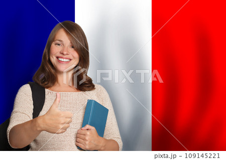 Happy woman student against French flag background. Travel, education and learn language 109145221