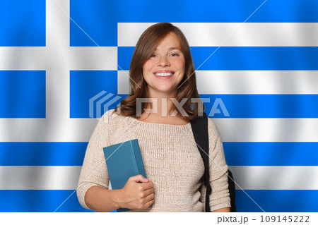 Cheerful woman student against Greek flag background. Travel, education and learn language 109145222