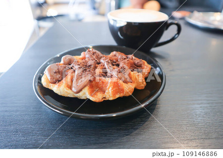 chocolate waffle or waffle with chocolate topping and coffee 109146886