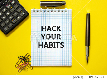 Hack your habits symbol. Words 'Hack your habits' on white note. Yellow background, paper clips, metallic pen and calculator. Business, psychology and hack your habits concept. Copy space. 109147624