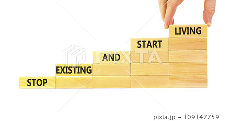 Stop existing start living symbol. Concept words Stop existing and start living on wooden blocks. Beautiful white table white background. Business Stop existing start living concept. Copy space. Stop existing start living symbol. Concept words Stop existing and start living on wooden blocks. Beautiful white table white background. Business Stop existing start living concept. Copy space. 109147759