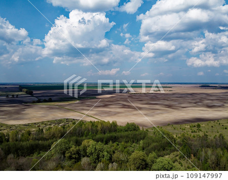 Beautiful blue sky over woodland, aerial view. Agricultural land. 109147997