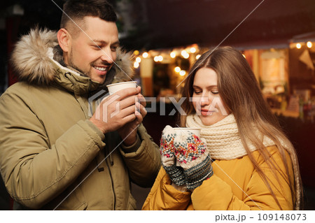 Happy couple with mulled wine at winter fair Happy couple with mulled wine at winter fair 109148073