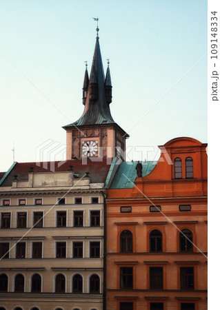 A clock tower in Prague with a red roof and a blue sky. A clock tower in Prague with a red roof and a blue sky. 109148334