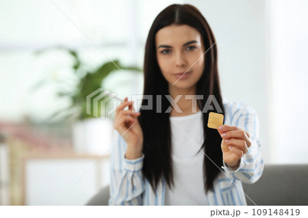 Happy young woman with nicotine patch and cigarette at home, focus on hand Happy young woman with nicotine patch and cigarette at home, focus on hand 109148419