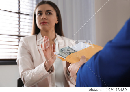 Businesswoman rejecting bribe in office, focus on money 109148480
