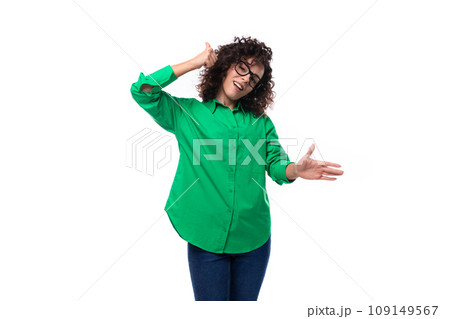 well-groomed young marketing employee woman in glasses is dressed in a green blouse and jeans 109149567