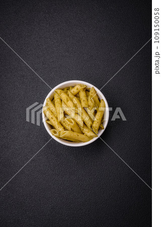 Delicious fresh pasta penne with green pesto sauce with basil, salt and spices 109150058