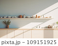 Interior of modern minimalist Scandi style kitchen. White facades, open shelves with utensils and dinnerware, wooden countertop, home appliances, beautiful light from window. Contemporary home design. 109151925