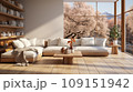 Interior of stylish spacious living room in luxury cottage. Comfortable corner sofa with cushions, rustic wooden coffee table, bookshelves on the wall, panoramic windows overlooking scenic landscape. 109151942