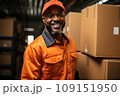 Portrait of an adult African American worker in warehouse against the background of cardboard boxes. Confident smiling male employee prepares parcels for dispatch and delivery. Logistic and delivery. 109151950