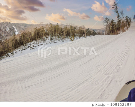 Groomed snow after a snow cat. Velvet ski texture. Fresh snow groomer tracks on a mountain ski piste Groomed snow after a snow cat. Velvet ski texture. Fresh snow groomer tracks on a mountain ski piste 109152297
