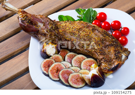 Lamb shoulder baked with figs, feta, tomatoes Lamb shoulder baked with figs, feta, tomatoes 109154275