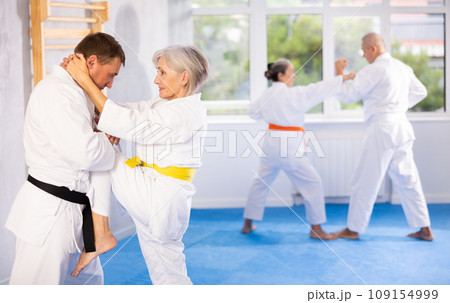 Senior judo practitioner engage in fierce fight 109154999
