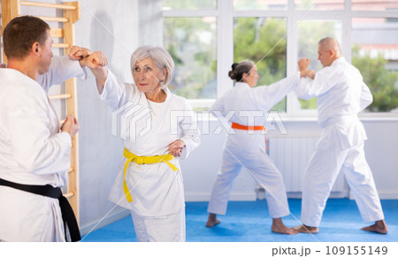 Senior karate practitioner engage in fierce fight oriental single combat 109155149