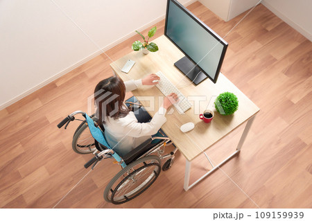 PC作業をする車イスの女性 109159939