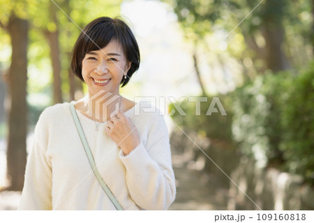 公園を散歩する50代の女性 公園を散歩する50代の女性 109160818