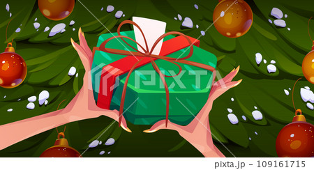 Female hands holding gift box, Christmas tree 109161715