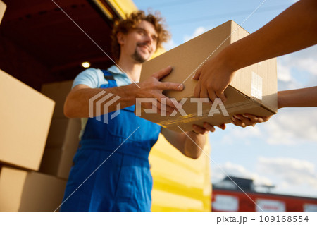 Closeup transferring of parcel cardboard box from hand to hand 109168554