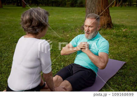 Happy older couple of retirees doing training workout in park 109168699