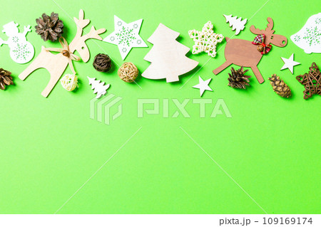 Christmas green background with holiday toys and decorations. Happy New Year concept with empty space for your design 109169174