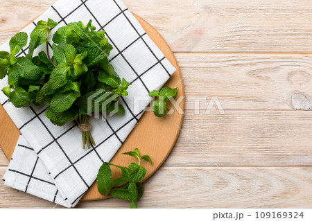 Fresh mint on Cutting board table, top view. Flat lay Space for text Fresh mint on Cutting board table, top view. Flat lay Space for text 109169324