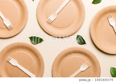 set of empty reusable disposable eco-friendly plates, cups, utensils on light white colored table background. top view. Biodegradable craft dishes. Recycling concept. Close-up set of empty reusable disposable eco-friendly plates, cups, utensils on light white colored table background. top view. Biodegradable craft dishes. Recycling concept. Close-up 109169374