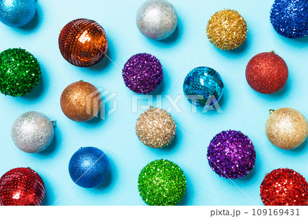 Top view of creative holiday baubles on colorful background. Christmas ornament concept Top view of creative holiday baubles on colorful background. Christmas ornament concept 109169431