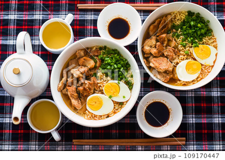 Japanese ramen with chicken and soy sauce on the table with teapot and green tea 109170447