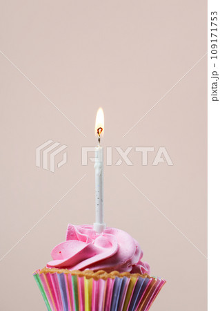 Colorful cupcake with single birthday candle. 109171753