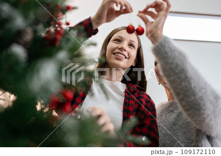 Woman decorate for Christmas at home. Family celebrate and Happy new year at home Woman decorate for Christmas at home. Family celebrate and Happy new year at home 109172110