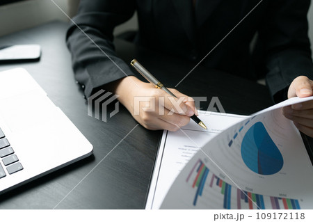 Businesswoman signing a document for approve with partner in a folder Businesswoman signing a document for approve with partner in a folder 109172118