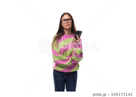 young cheerful charming caucasian woman with straight black hair dressed in a stylish autumn striped young cheerful charming caucasian woman with straight black hair dressed in a stylish autumn striped 109173142