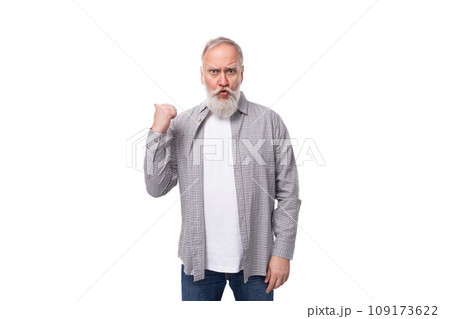 a cute grandfather with a white beard and mustache is wearing a striped shirt over a t-shirt 109173622