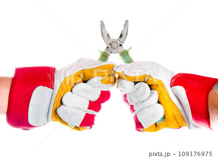 gloved hand with pliers 109176975