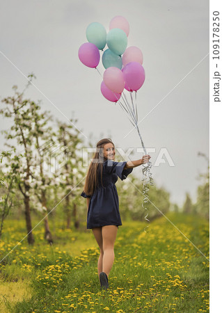 girl with balloons in a young garden 109178250