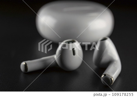ROSTOV-ON-DON, RUSSIA - APRIL 28, 2018: Apple AirPods wireless Bluetooth headphones and charging case for Apple iPhone. New Apple Earpods Airpods in box. ROSTOV-ON-DON, RUSSIA - APRIL 28, 2018: Apple AirPods wireless Bluetooth headphones and charging case for Apple iPhone. New Apple Earpods Airpods in box. 109178255