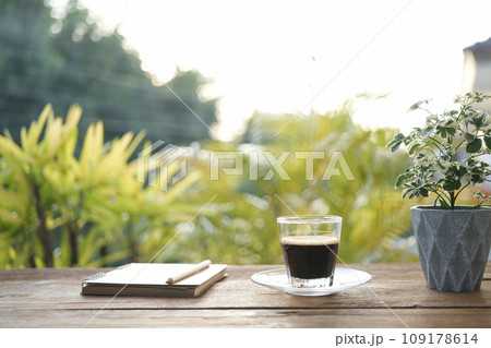coffee glass cup and diary notebooks and plant pot chill outdoor drinking 109178614