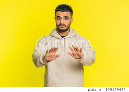 Strict Indian man warning hands gesture, saying no, be careful, advice to avoid danger, caution 109179445