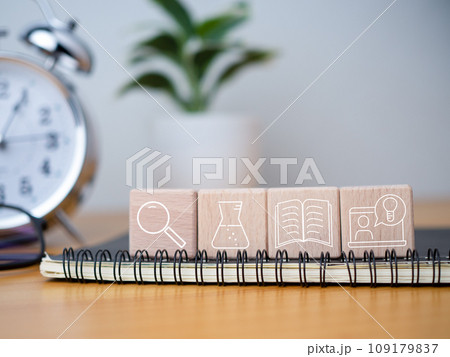 Educational concept Creativity and innovation Square wooden blocks are arranged together with educational icons on top of a notebook. 109179837