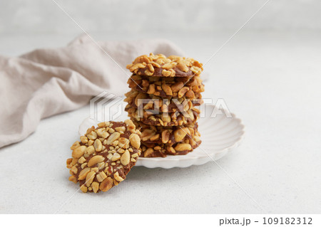 A heap of Portugues traditional peanut cookies known as Bolachas de Amendoim on the white plate 109182312