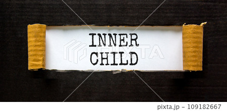 Inner child symbol. Concept words Inner child on beautiful white paper. Beautiful black table black background. Psychological, motivational inner child concept. Copy space. 109182667