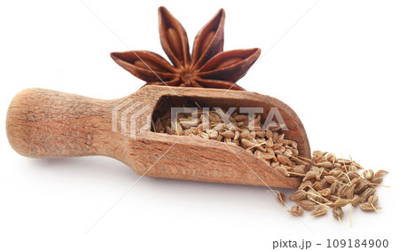 Anise seeds in wooden scoop and Star anise Anise seeds in wooden scoop and Star anise 109184900