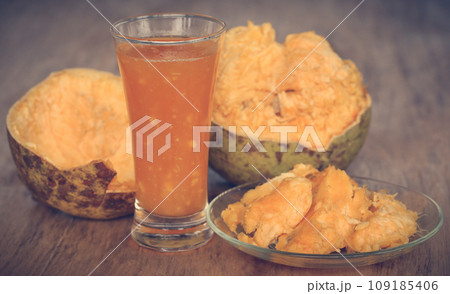 Medicinal Bael fruit with juice in a glass Medicinal Bael fruit with juice in a glass 109185406