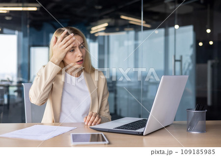 Frustrated sad upset woman working inside office, business woman got bad achievement result, female worker unhappy reading data from laptop screen. Frustrated sad upset woman working inside office, business woman got bad achievement result, female worker unhappy reading data from laptop screen. 109185985
