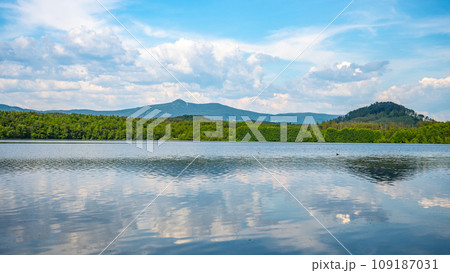 Landscape with Jested Mountain ridge reflected in water of Hamr Lake, or Hamr Pond. Czech Republic 109187031